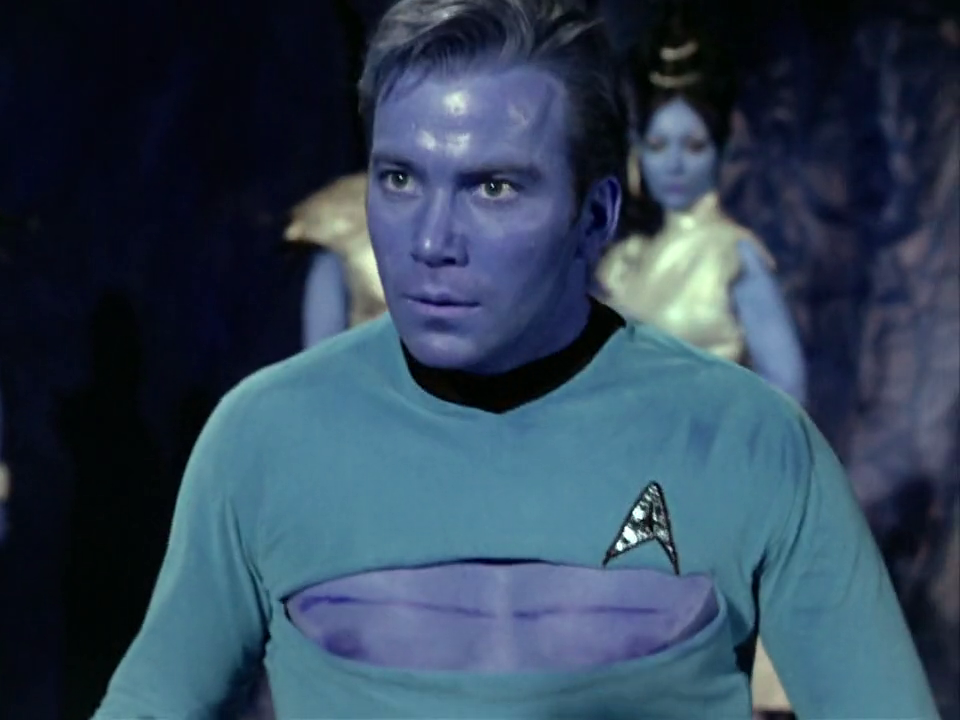 Kirk from the Star Trek episode "Amok Time", looking shocked with a torn open shirt.
The color channels are fucked up, resulting in his skin being a bright blue color 