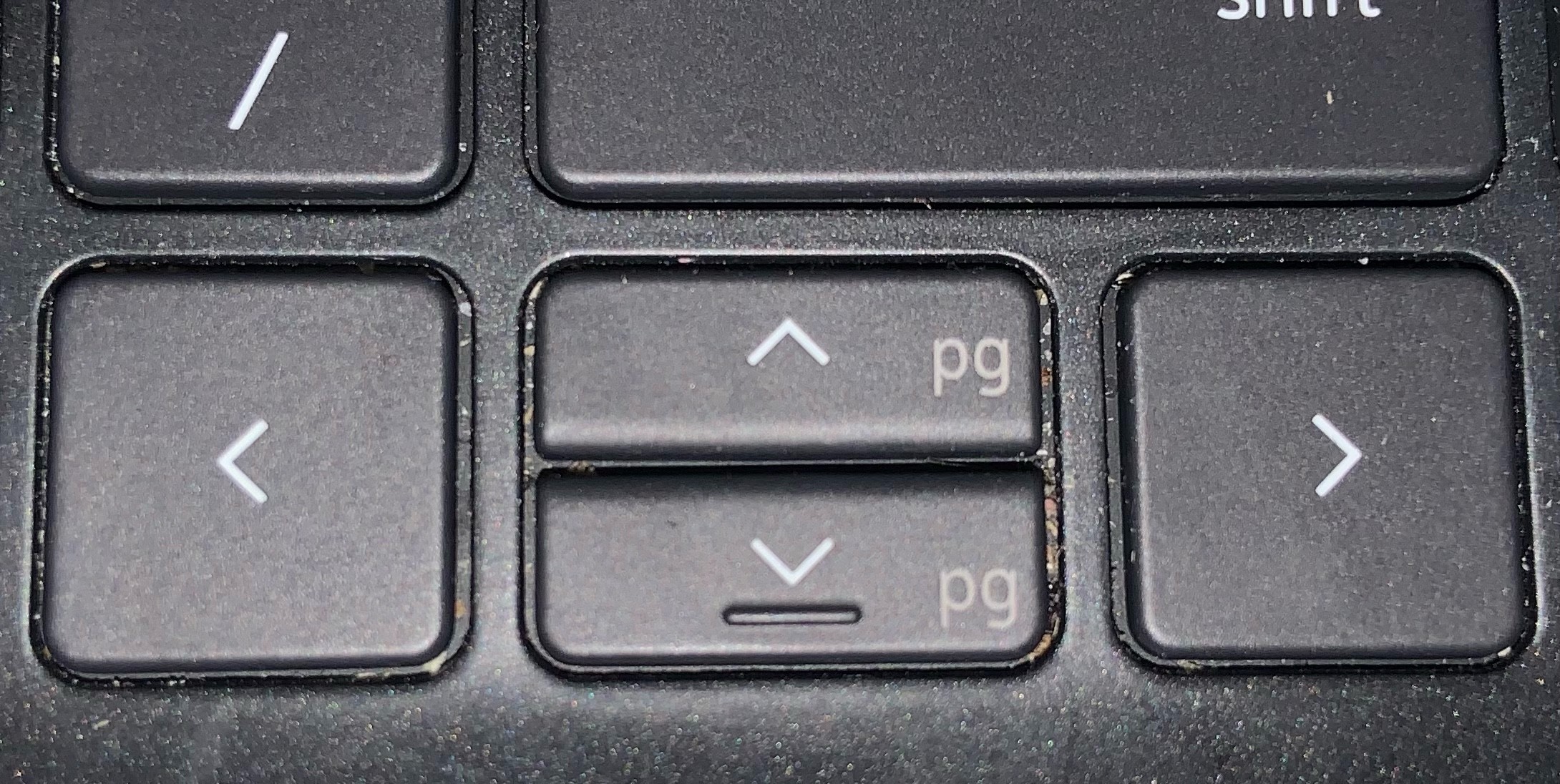 a cursor key cluster where left and right are normal but up and down are half-height each and crammed into the space between left and right. 